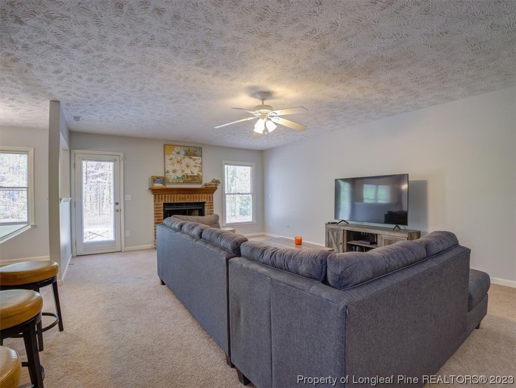 433 Wapiti Drive Spring Lake, NC 28390 - Photo 7 of 31 a living room with furniture and a fireplace