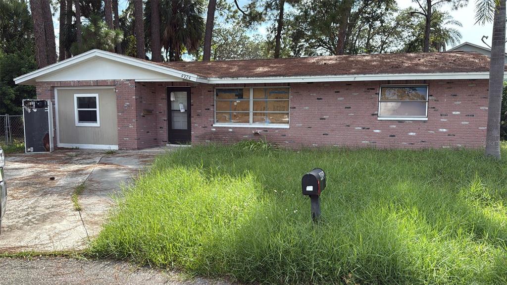 4924 Cherry Court New Port Richey, FL 34652 - Photo 1 of 1 a front view of a house with a yard and garage
