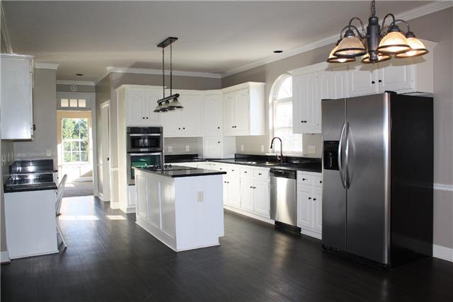 400 Fairway Trail Springfield, TN 37172 - Photo 5 of 20 Directly off the dining and living room is this enormous kitchen! Plentiful white cabinets, granite counter tops, stainless appliances and tons of built in storage! Also, there is a large eat in area for a breakfast table.