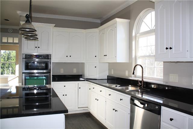 400 Fairway Trail Springfield, TN 37172 - Photo 6 of 20 A closer look at the kitchen. Check out the large island with cooktop, double oven/ microwave. large window and gorgeous crown moulding!