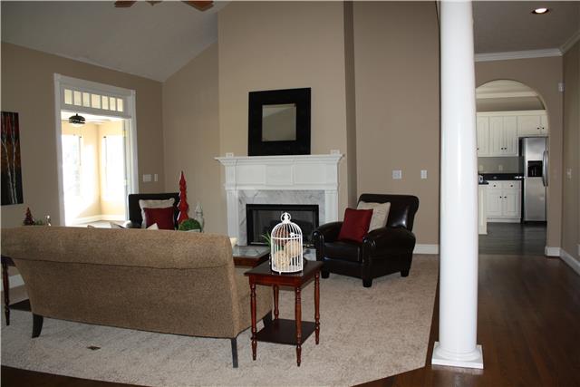 400 Fairway Trail Springfield, TN 37172 - Photo 10 of 20 The opposite view of the living room showing the arched doorway to the kitchen, the other doorway to the sun/ bonus room and the beautiful fireplace! Not pictured is a half bath, perfect for your guests!