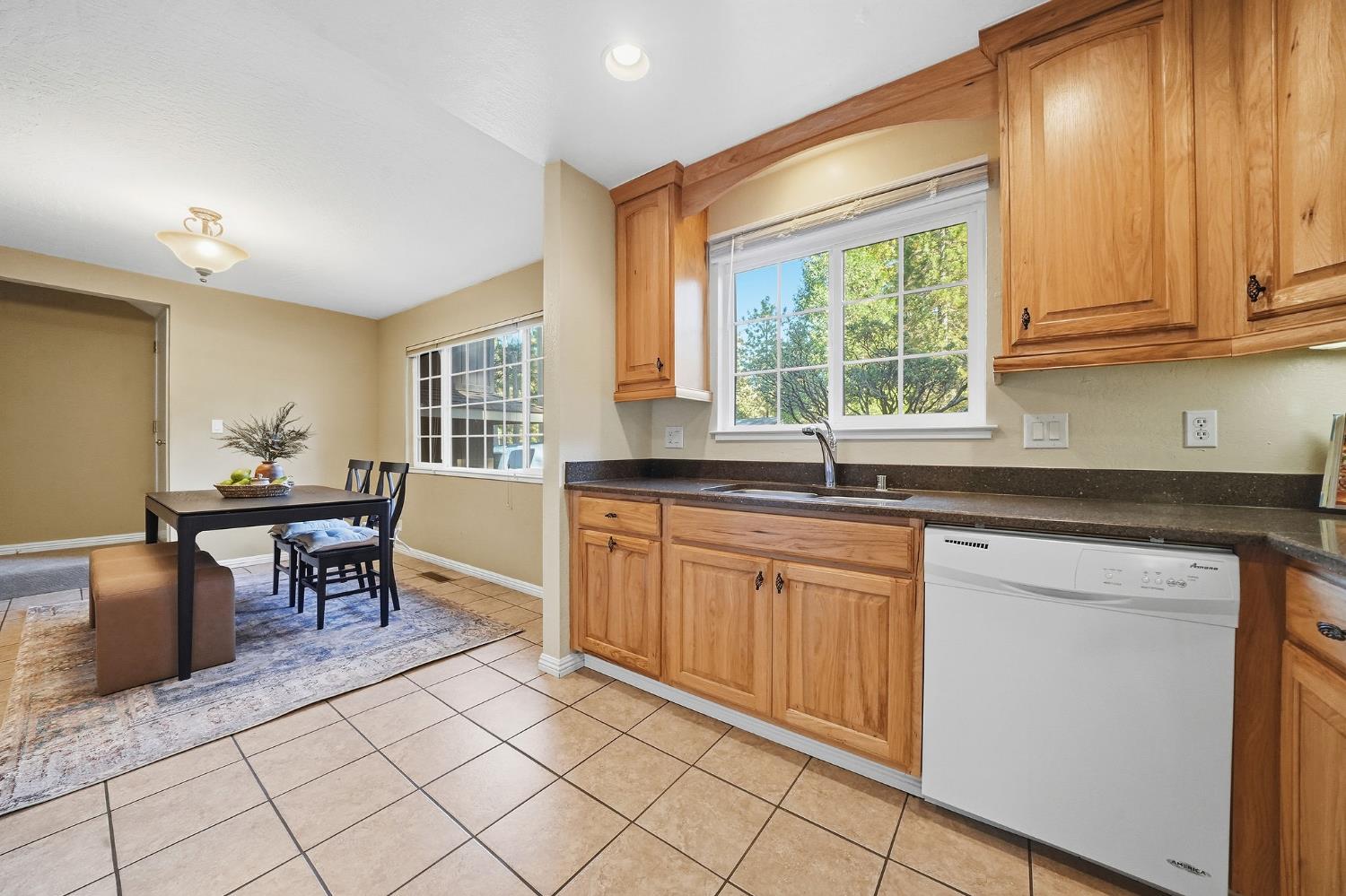 26019 Ridge Drive Pioneer, CA 95666 - Photo 21 of 75 a kitchen with stainless steel appliances granite countertop a stove a sink and a microwave