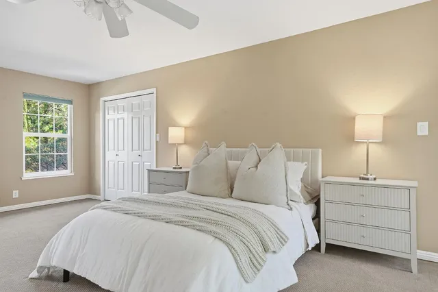a bedroom with a large bed and a chandelier