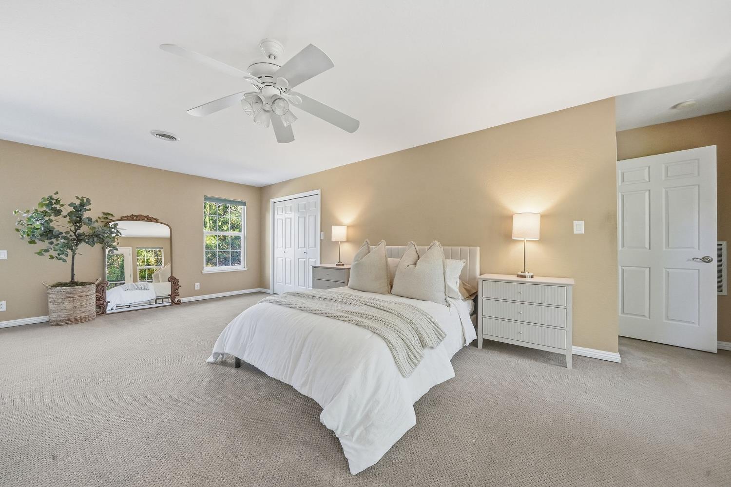 26019 Ridge Drive Pioneer, CA 95666 - Photo 24 of 75 a spacious bedroom with a bed and a chandelier