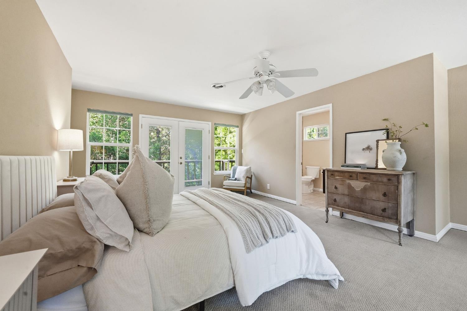 26019 Ridge Drive Pioneer, CA 95666 - Photo 27 of 75 a bedroom with a bed and a chandelier