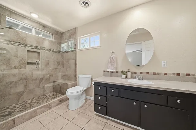 a bathroom with a double vanity sink and mirror