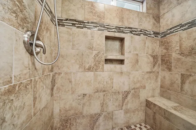 an empty room with windows and ceiling fan