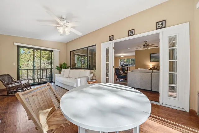 a view of empty room with window and ceiling fan