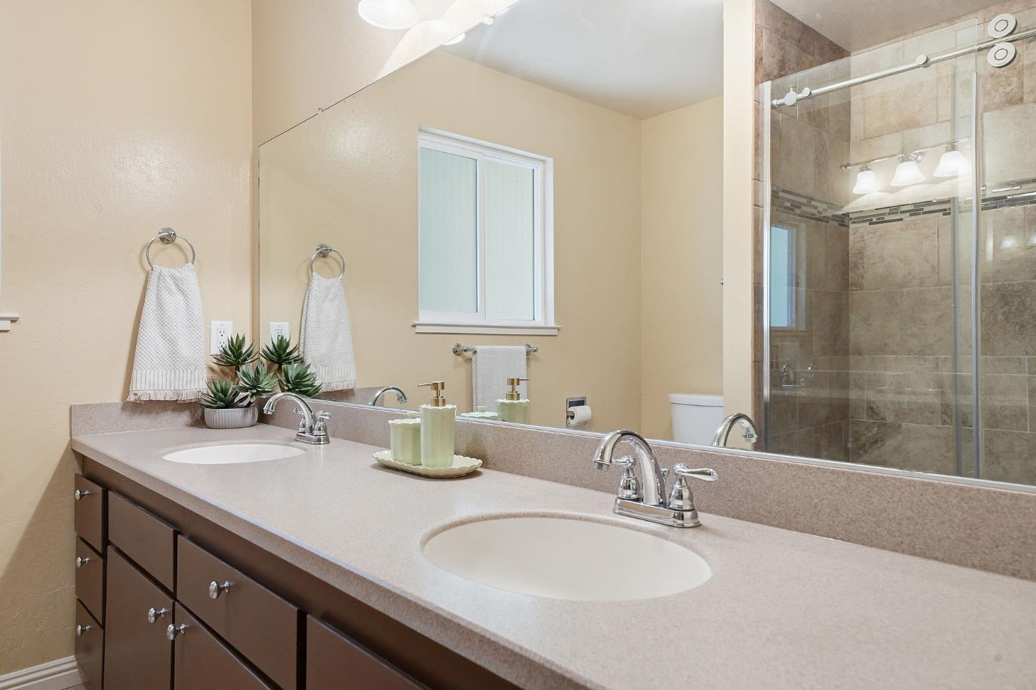 26019 Ridge Drive Pioneer, CA 95666 - Photo 43 of 75 a bathroom with double vanity sinks and a mirror