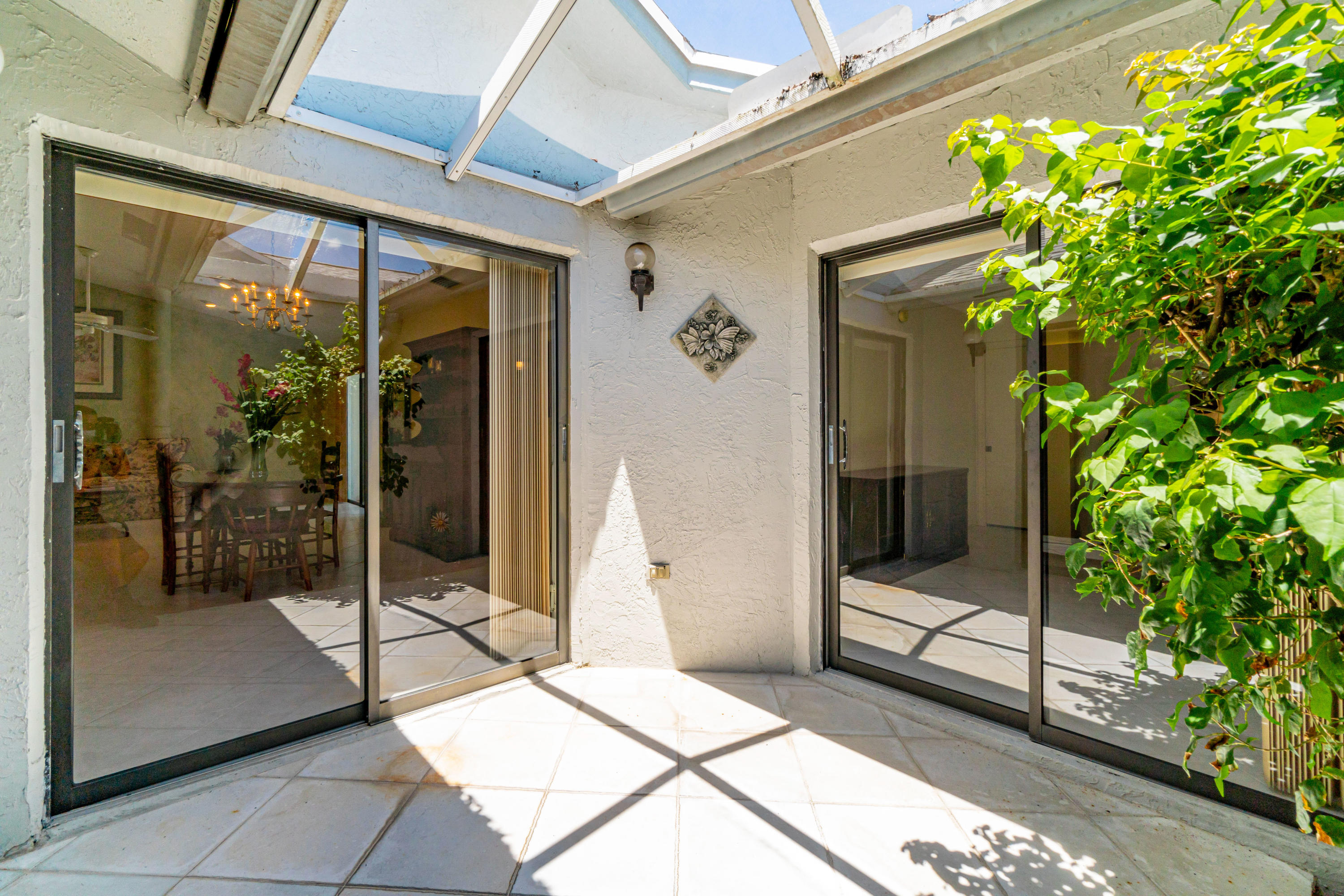 9159 Southwest 22nd Street, Unit D Boca Raton, FL 33428 - Photo 13 of 35 a bath room with a glass door and glass door