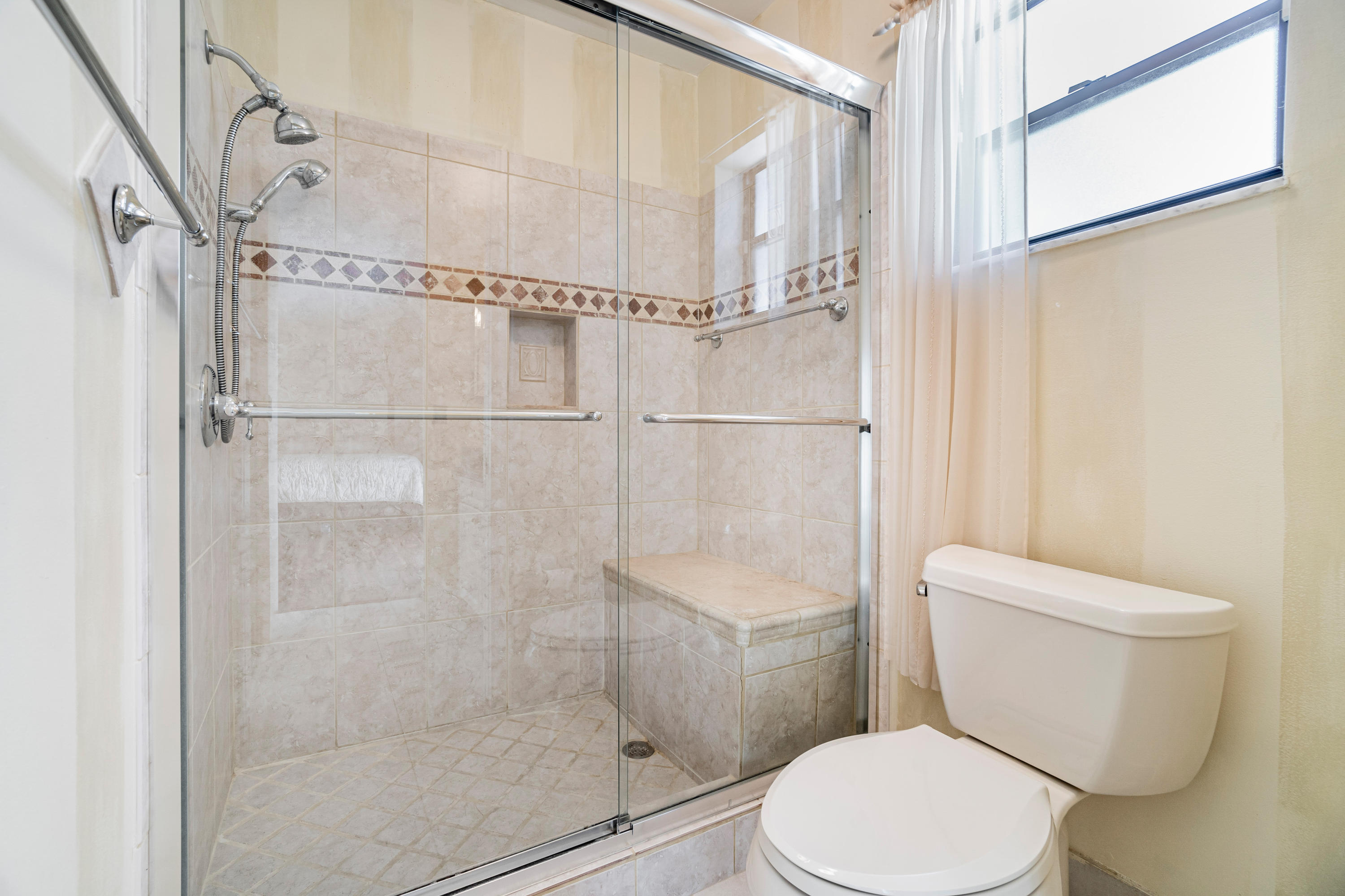 9159 Southwest 22nd Street, Unit D Boca Raton, FL 33428 - Photo 21 of 35 a white toilet sitting next to a shower