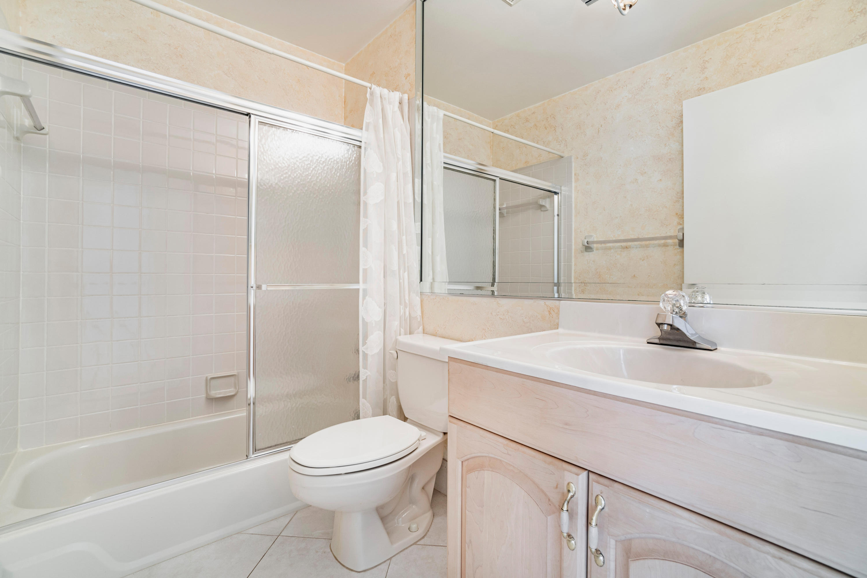 9159 Southwest 22nd Street, Unit D Boca Raton, FL 33428 - Photo 24 of 35 a bathroom with a sink a toilet and shower