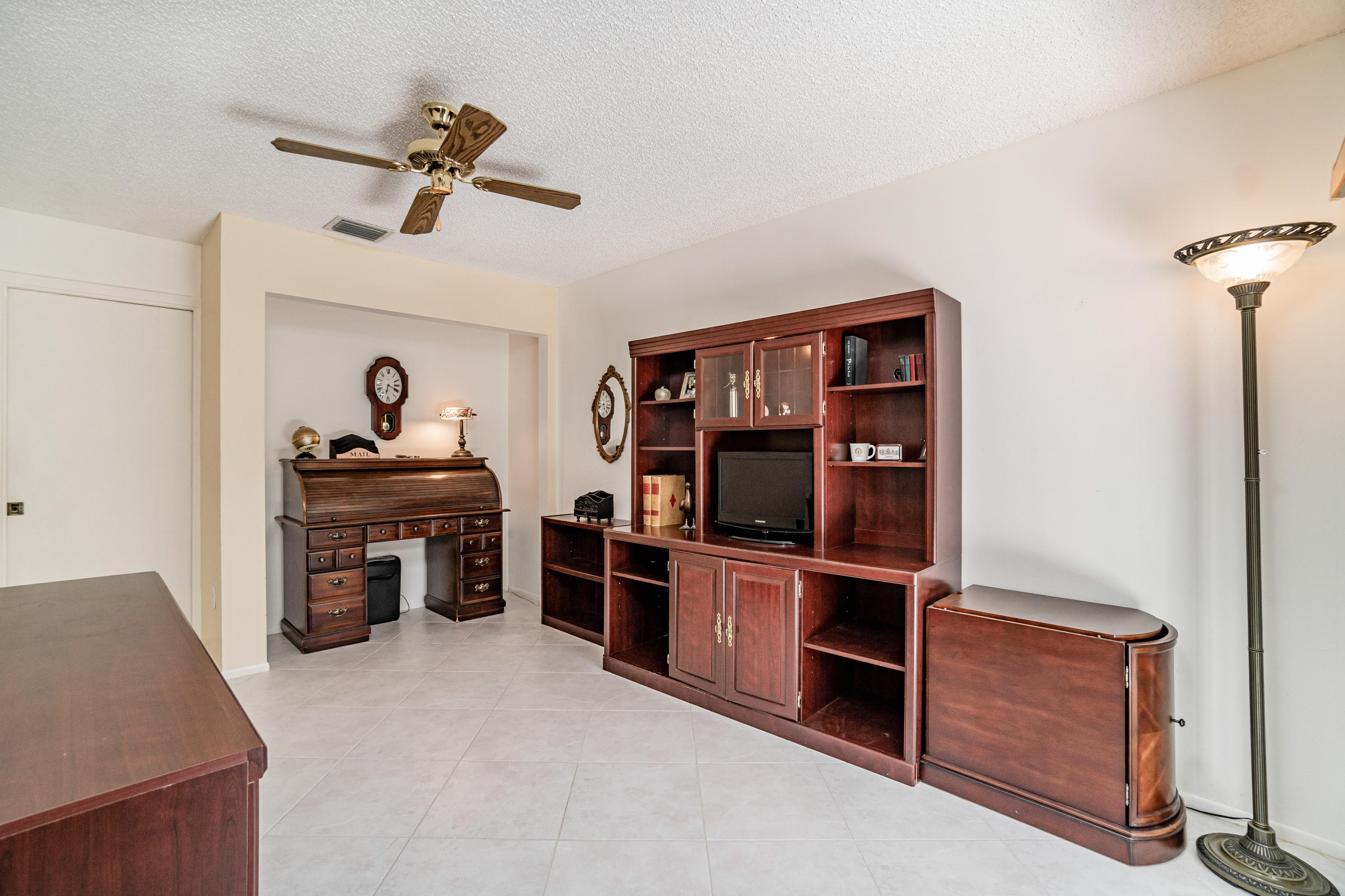 9159 Southwest 22nd Street, Unit D Boca Raton, FL 33428 - Photo 26 of 35 a living room with furniture and a flat screen tv