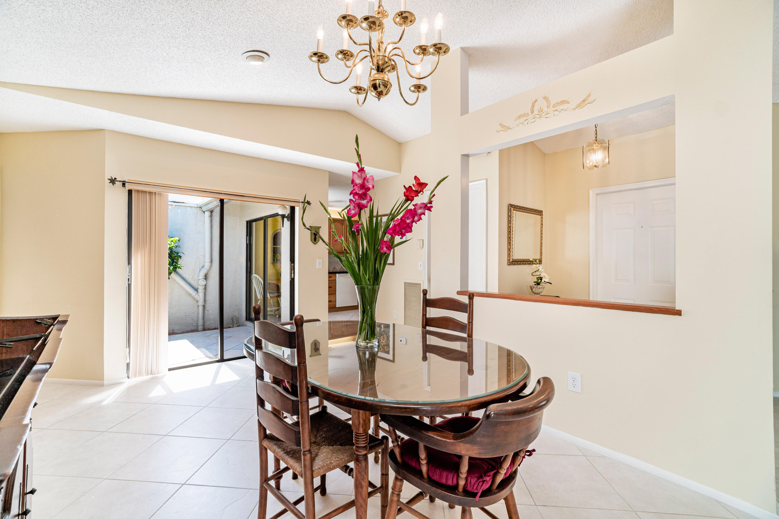 9159 Southwest 22nd Street, Unit D Boca Raton, FL 33428 - Photo 3 of 35 a view of a dining room with furniture and a chandelier