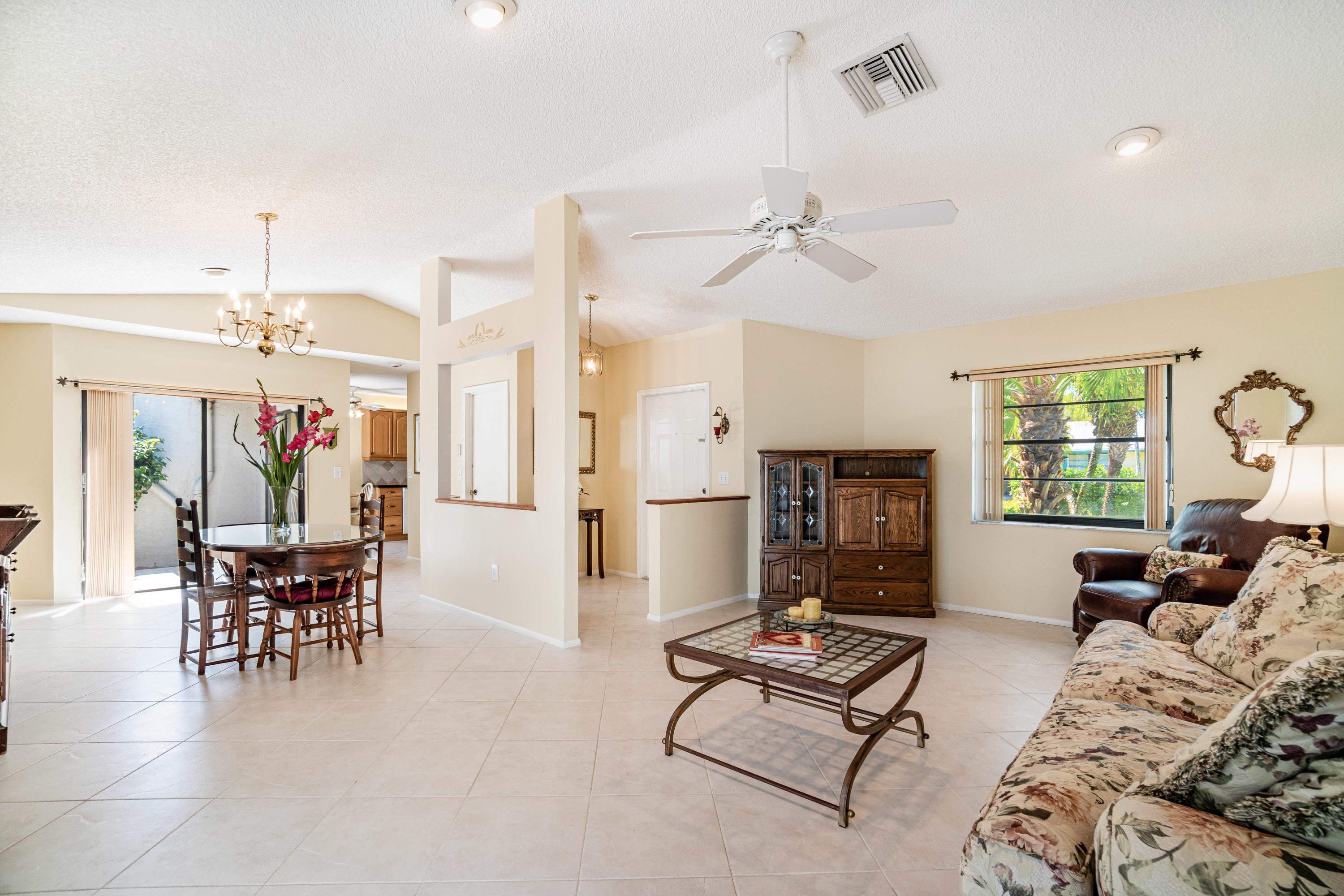 9159 Southwest 22nd Street, Unit D Boca Raton, FL 33428 - Photo 6 of 35 a living room with furniture and a chandelier