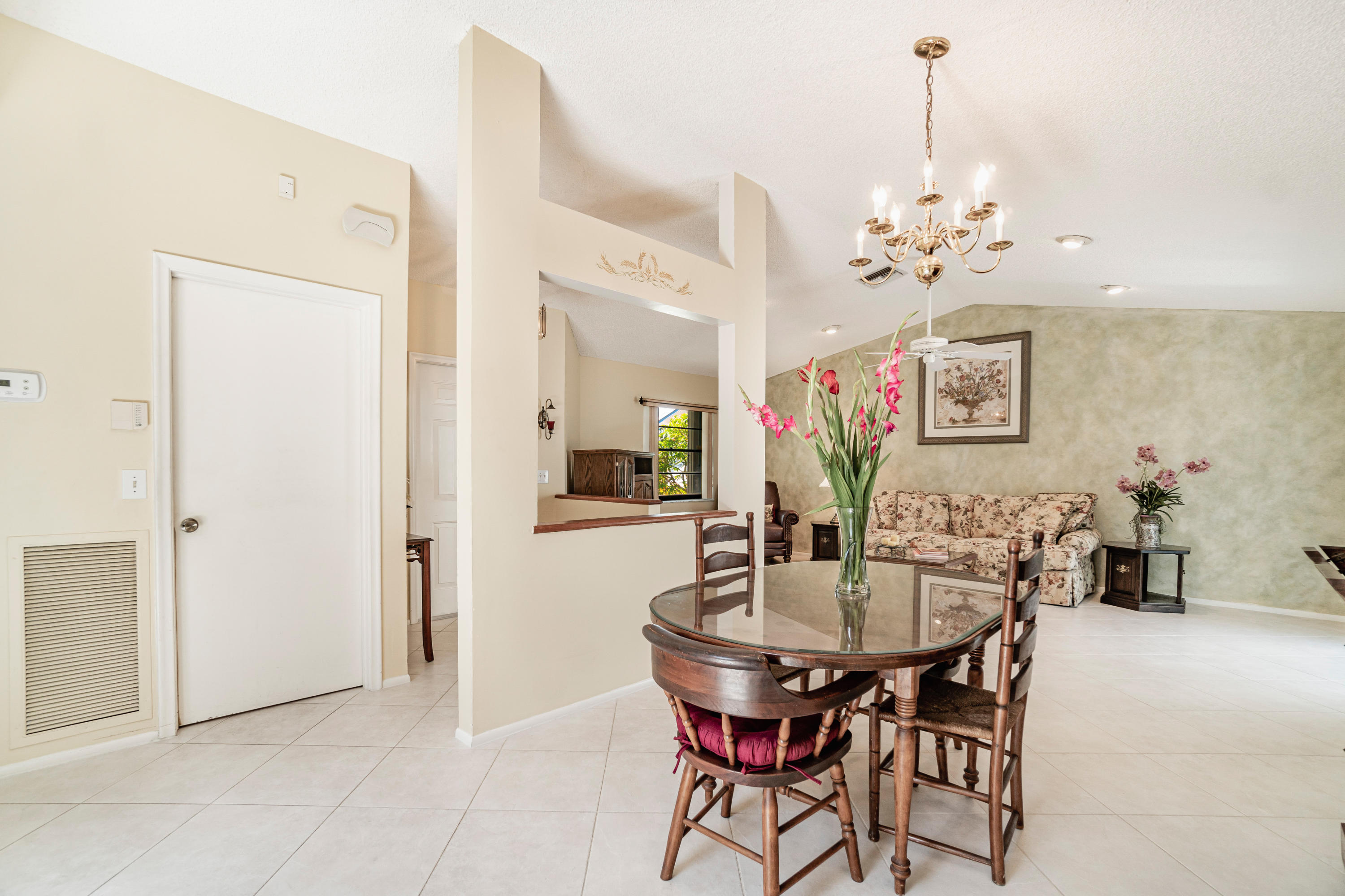 9159 Southwest 22nd Street, Unit D Boca Raton, FL 33428 - Photo 8 of 35 a view of a dining room with furniture and chandelier