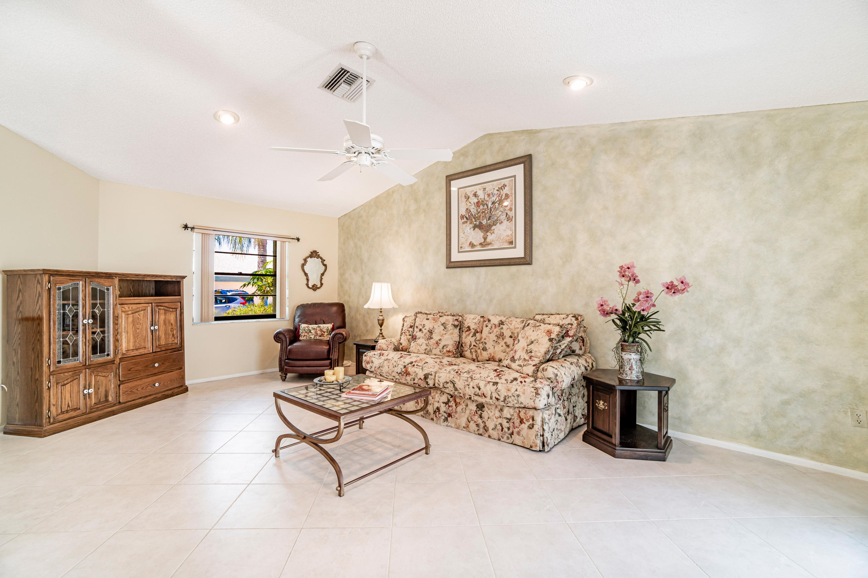 9159 Southwest 22nd Street, Unit D Boca Raton, FL 33428 - Photo 10 of 35 a living room with furniture and a flat screen tv