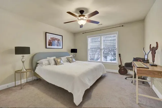 a spacious bedroom with a bed and a large window