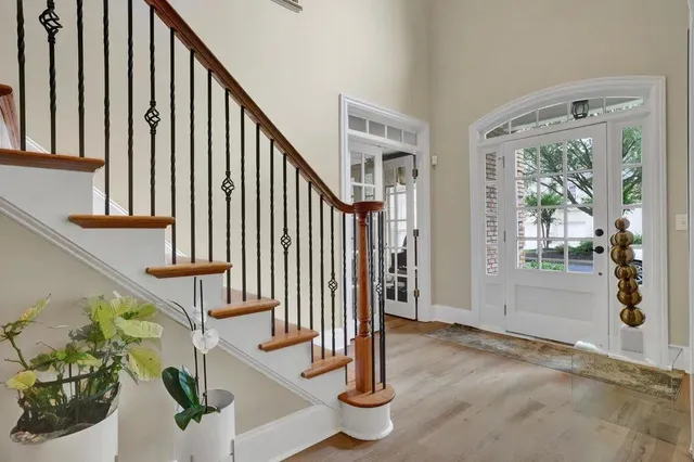 a view of entryway with wooden floor and stairs