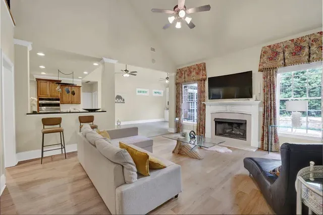 a living room with furniture a fireplace and a flat screen tv