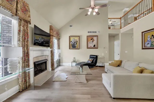 a living room with furniture a fireplace and a flat screen tv