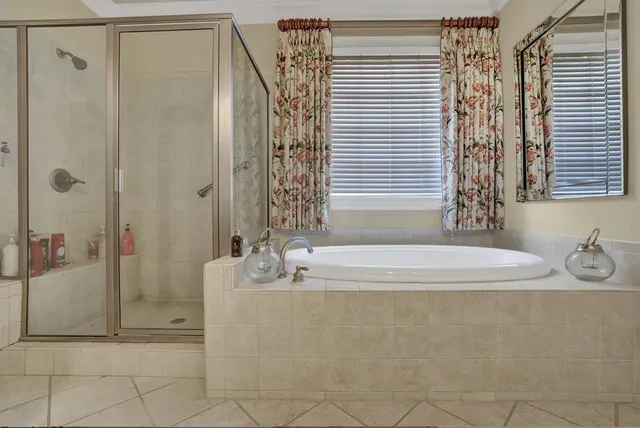 a spacious bathroom with a bathtub and shower