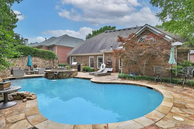 a bathroom with a granite countertop sink a toilet and shower