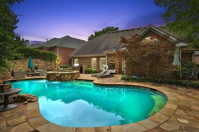 a view of a house with swimming pool and sitting area