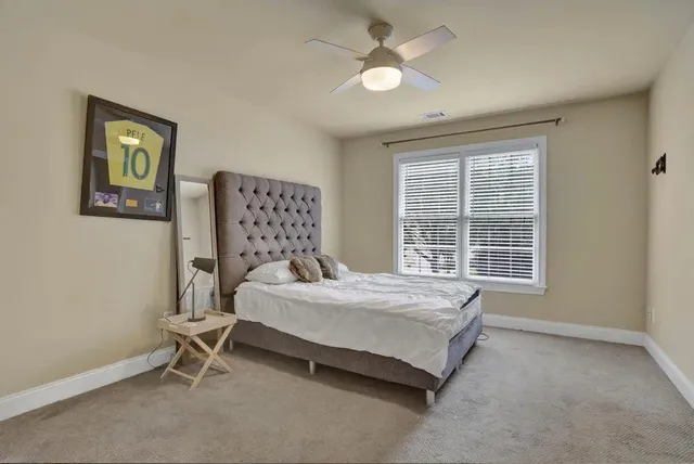 a spacious bedroom with a bed and a window