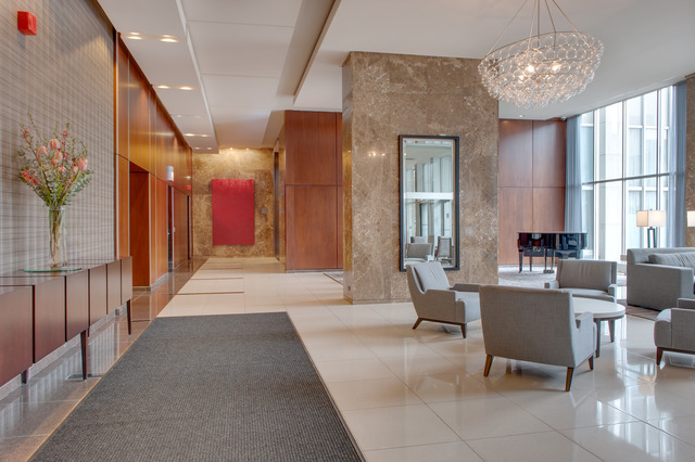655 West Irving Park Road, Unit 1114 Chicago, IL 60613 - Photo 10 of 14 a living room with furniture and a chandelier