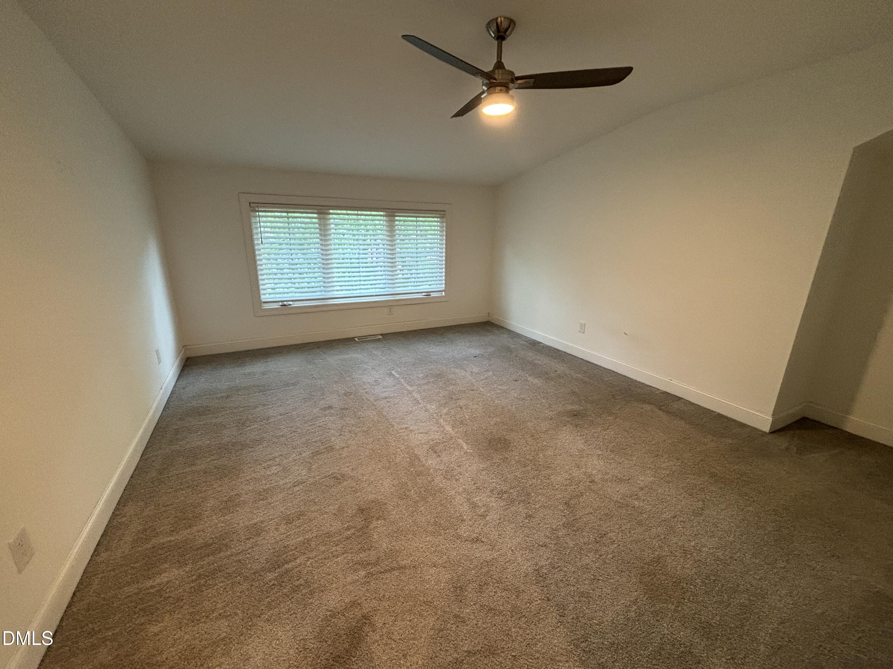 5710 Parker Pnes Court Raleigh, NC 27609 - Photo 70 of 78 an empty room with a ceiling fan and window