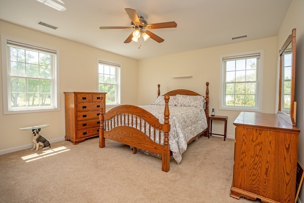 41 Waid Road Monson, MA 01057 - Photo 17 of 29 a bedroom with a bed a chandelier and a dresser
