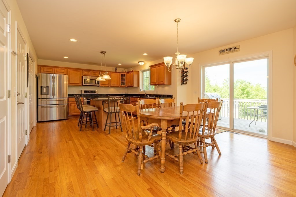 41 Waid Road Monson, MA 01057 - Photo 4 of 29 a view of a dining room and livingroom with furniture wooden floor a chandelier