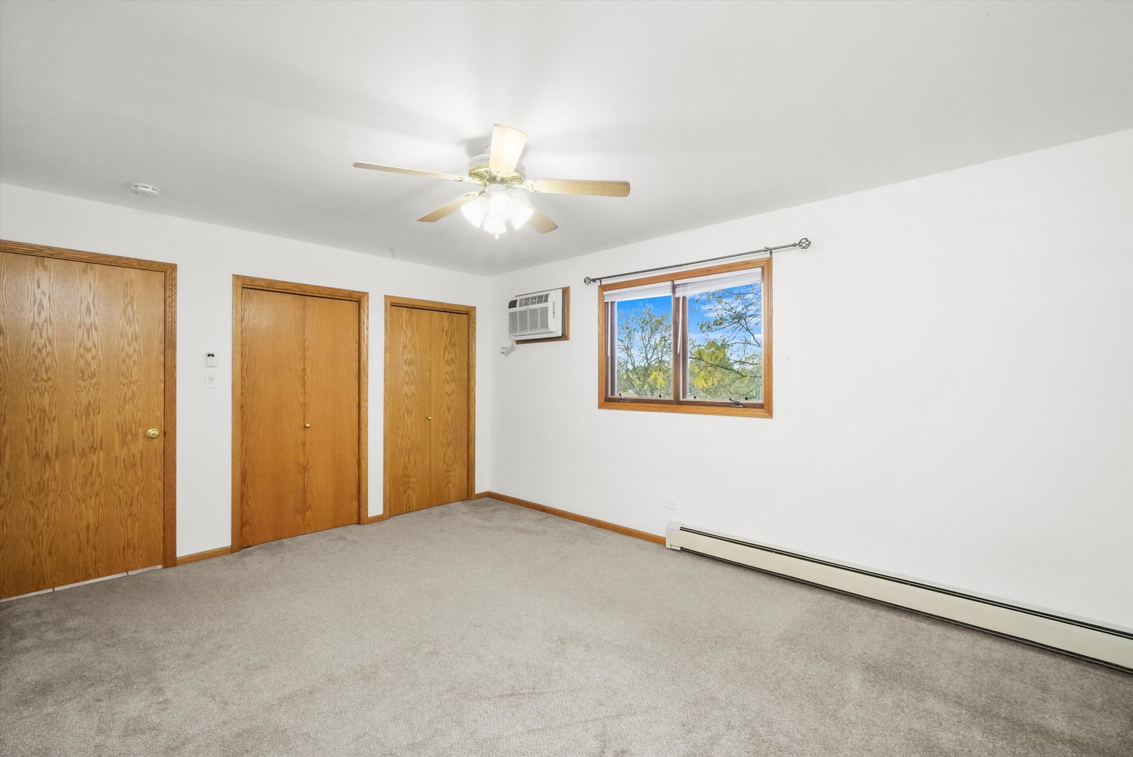 9016 West 140th Street, Unit 3A Orland Park, IL 60462 - Photo 13 of 25 an empty room with windows and fan