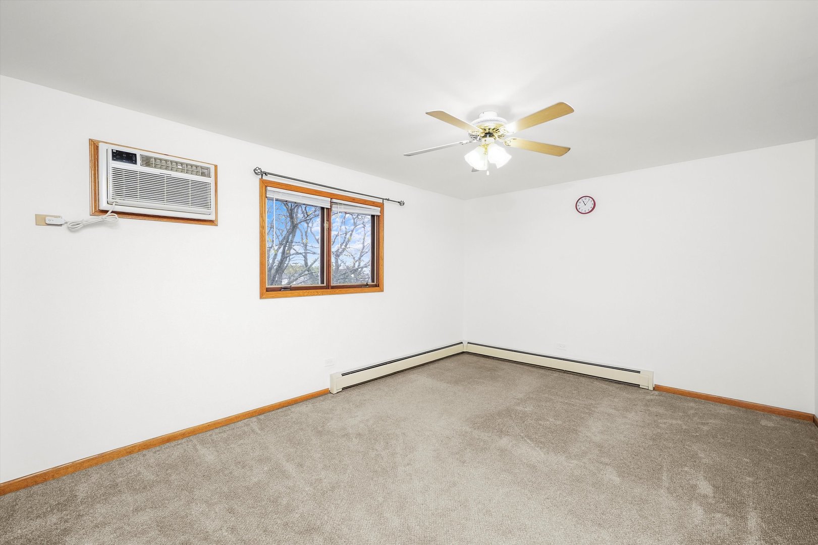 9016 West 140th Street, Unit 3A Orland Park, IL 60462 - Photo 14 of 25 an empty room with a window and a fan