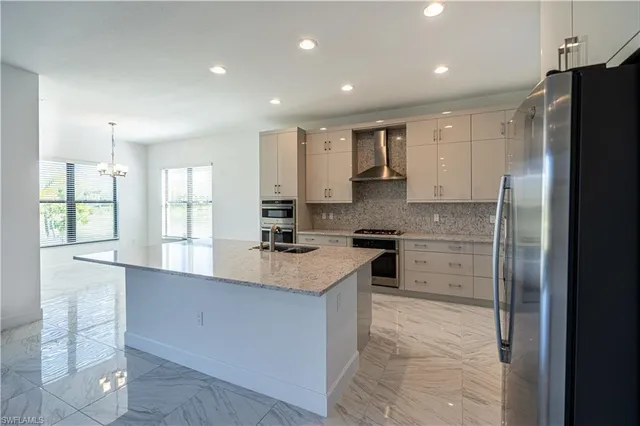 a kitchen with a refrigerator and a sink