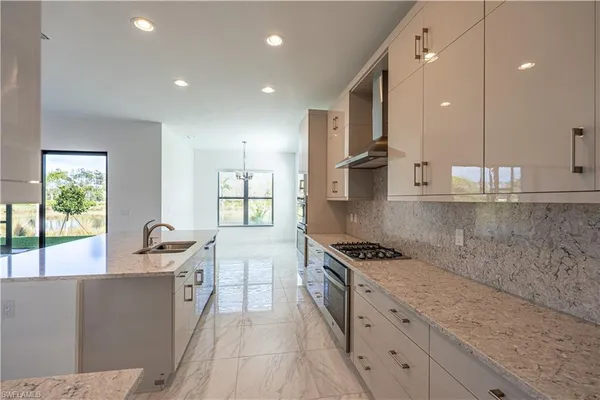 a kitchen with stainless steel appliances granite countertop a sink and cabinets