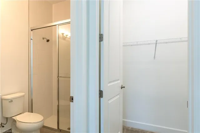 a bathroom with a toilet and a shower