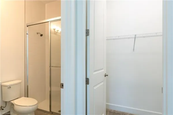 a bathroom with a toilet and a shower