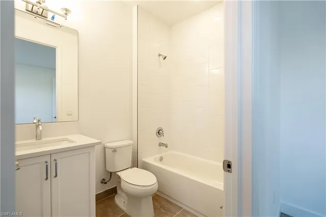 a bathroom with a sink mirror toilet and bathtub