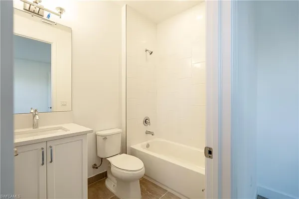 a bathroom with a sink mirror toilet and bathtub