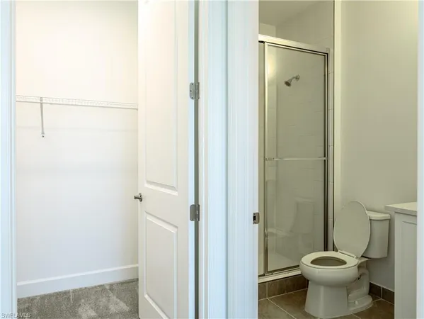 a bathroom with a toilet and a shower
