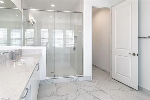 a bathroom with a shower and a sink
