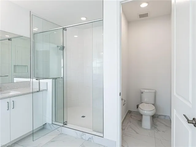 a bathroom with a shower and a toilet