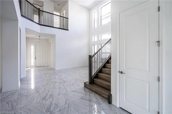 a view of a hallway with wooden floor and entryway