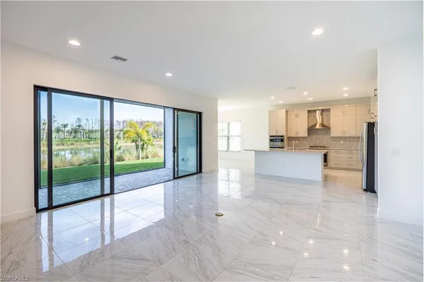 a view of large kitchen with a large window and stainless steel appliances