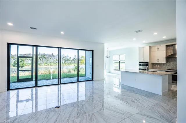 a view of large kitchen with granite countertop lots of counter top space and stainless steel appliances