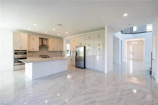 a large kitchen with a lot of counter space and stainless steel appliances