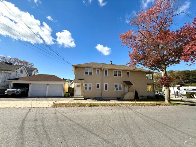 a view of a car parked front of a house