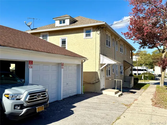 a view of street along with house and trees